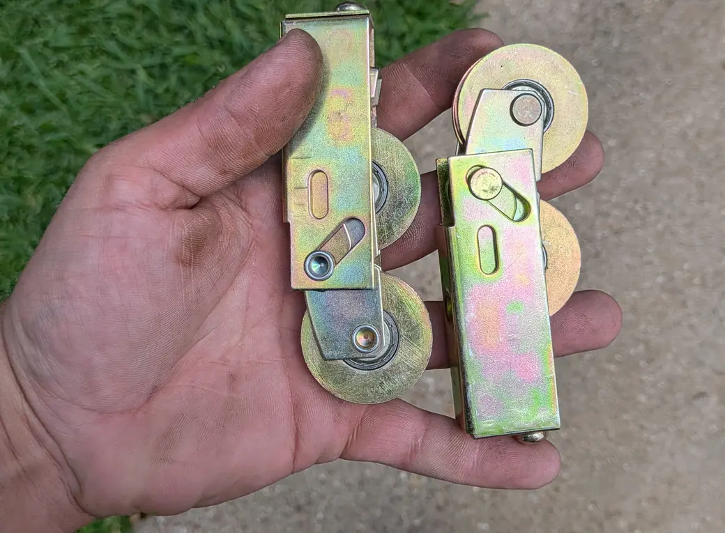 New sliding door roller assemblies held by a technician
